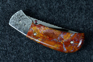 "Bellatrix" custom folding knife, reverse side showing that the thumb stud has bezel-set garnets on both sides for easy opening