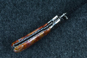 "Bellatrix" custom folding knife, inside handle view, showing blue-gray titanium liners and lockup area, dovetailed bolsters