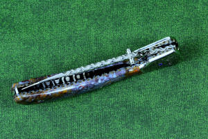 "Starling" fine handmade custom folding knife, liner and blade filework detail. Note differentially anodized blue and gold titanium liners and full fine filework throughout