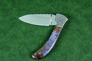 "Starling" fine handmade custom folding knife, obverse side view in high molybdenum stainless steel blade, engraved stainless bolsters, faceted amethyst gemstone accents and Rio Grande Agate handle