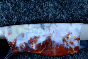 "Temno" reverse side gemstone handle detail, note the flames of carmine red in lavender-tinted white agate and numerous fossil forms in this 6 power enlargement